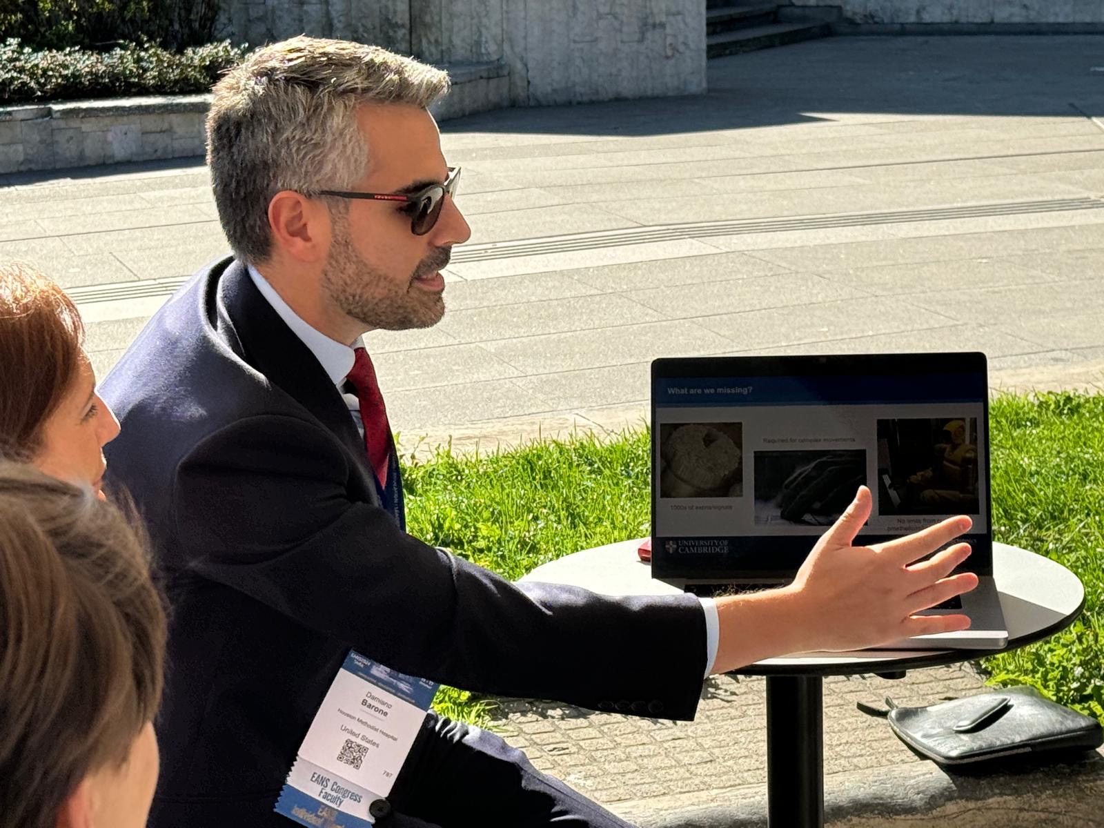 Dr. Damiano Barone discussing neural-interface research with colleagues